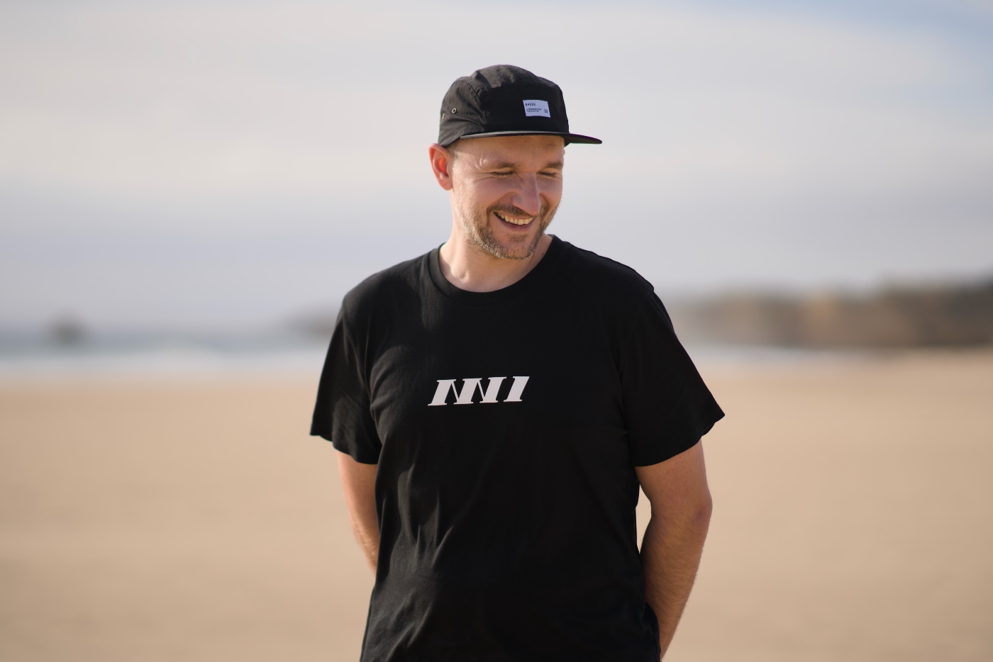 A family picture of three of us on the beach in Carvoeiro. Baby in the pushchair on the right, and hugging couple on the center of a frame.