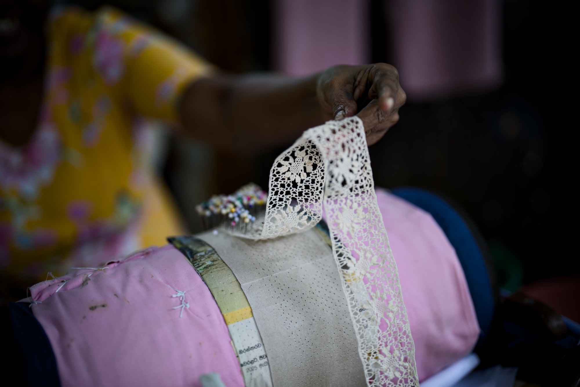 Lady showing the beautifully hand crafted thing. I don't even know what's the name of this thing.